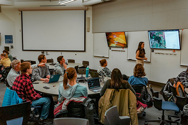 Barr employee presenting at the front of a classroom to a group of college students