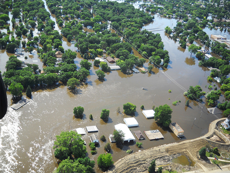 Aerial view of the 2011 Mouse River flood in Minot, North Dakota, capturing the scale of the disaster that spurred one of the state’s largest flood protection efforts.