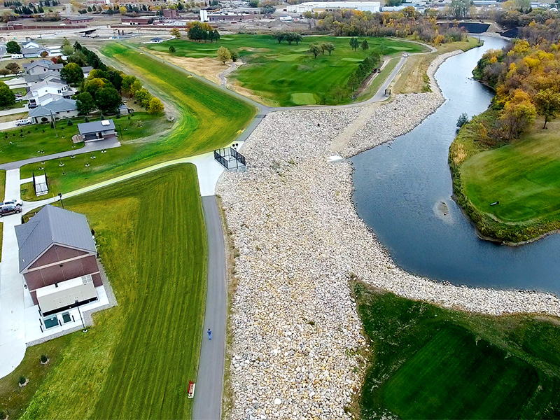 Drone view of the final restored project area along the Mouse River in Minot, North Dakota, highlighting stabilized banks, improved green space, and integrated neighborhood infrastructure.