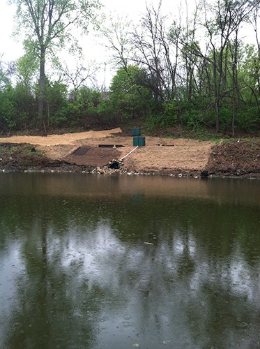 A row of crushed lime (white gravelly powder) and soil placed in a trench.
