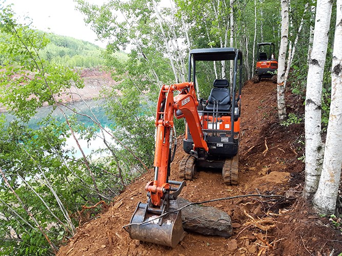 Construction equipment shaping the mountain bike trail for the Redhead project in northern Minnesota.